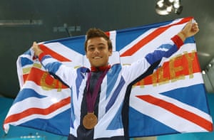 daley 2: Bronze medallist Tom Daley of Great Britain poses with the national flag