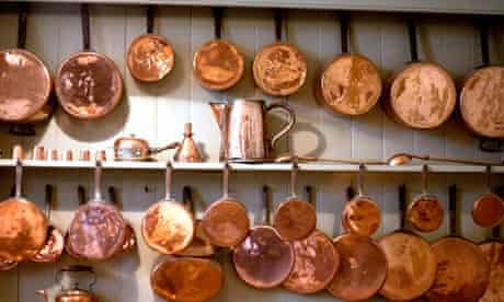 Copper pots and pans hanging in a kitchen