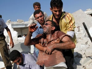 A Syrian man reacts after seeing the body of his relative buried in rubble after an air strike destroyed houses in the town of Azaz.