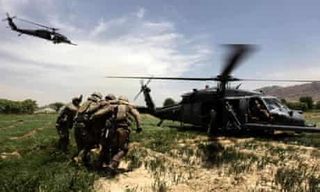 U.S. Army soldiers help an injured comrade into a helicopter in Arghandab valley near Kandahar