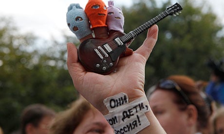 A Pussy Riot supporter holds finger puppets of the punk band