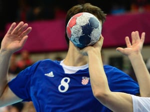 The ball hides the face of a Croatian player during the men's preliminary Group B handball match between Croatia and Hungary