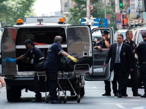 A body is moved by the New York City coroner near the site of the Empire State building where a gunman opened fire.