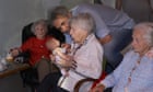 dementia village - resident plays with doll