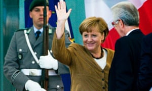 German Chancellor Angela Merkel (C) waves to spectators as she welcomes Italy's Prime Minister Mario Monti (R) for talks at the Chancellery in Berlin, August 29, 2012.