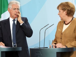 Italian Prime Minister Mario Monti (L) listens during a news conference with German Chancellor Angela Merkel at the German federal Chancellory on August 29, 2012 in Berlin, Germany.