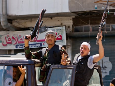 Rebel fighters of the Free Syrian Army hold up their rifles in the northern restive Syrian city of Aleppo, on 3 August. Photo: AFP/Getty Images/Veday Xhysmshiti