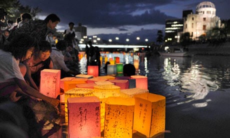 People release paper lanterns on the Motoyasu river to remember victims of the Hiroshima atomic bomb