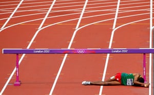 Olympic pain: Birhan Getahun of Ethiopia lies on the track in men's 3000m steeplechase