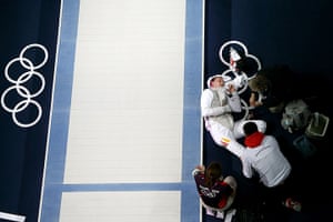 Olympic pain: Sebastian Bachmann of Germany has his injury tended to in the Fencing