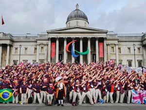 Olympic volunteers pose in front of the National Gallery before the victory parade