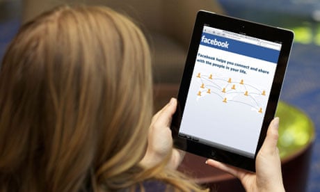A young woman using Facebook on an Ipad
