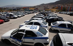 Greece scrapyard: Wrecked police vehicles in a yard