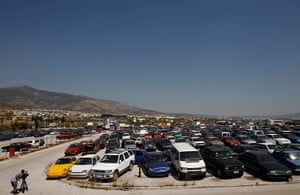 Greece scrapyard: A cameraman films confiscated cars in a yard 