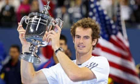 Andy Murray holds the US Open trophy, complete with sponsor's watch and anti-haircut