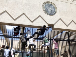 Protesters climb a fence at the US embassy in Sana'a September. Yemen's embassy in Washington said no casualties were reported.