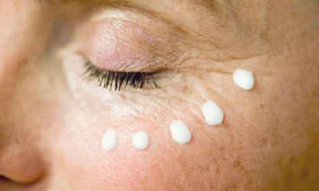 Splodges of anti-ageing cream around a woman's eye