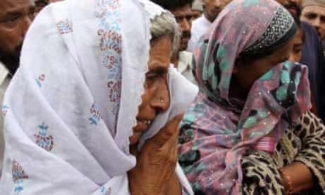 Relatives of a victim of the Karachi garment factory fire in Pakistan, that killed 289 people