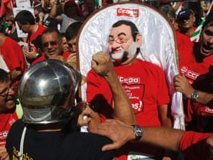 A fireman gestures towards a man dressed as Spanish prime minister Mariano Rajoy, centre, during protests in Columbus Square in Madrid on Saturday September 15, 2012.  Photograph: Andres Kudacki/AP