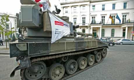 anti-arms trade protestors rive a tank past the German embassy in London
