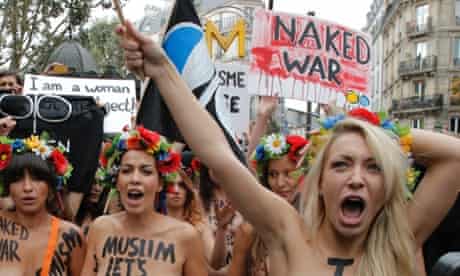 Activists of the women's rights group Femen chant slogans during a march in Paris where they have opened a headquarters in a move to recruit members in their fight against the discrimination of women.