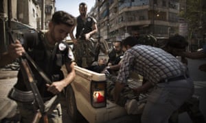 Syrian rebels help a survivor of a Syrian army attack to safety in Aleppo.