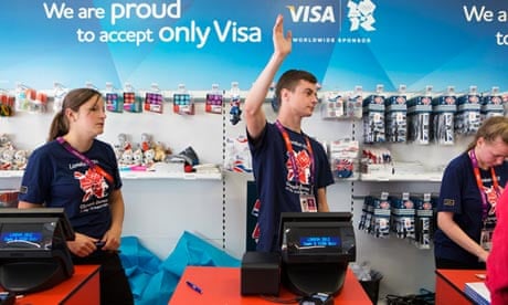A shop assistant calls the next customer at a shop selling Olympic merchandise
