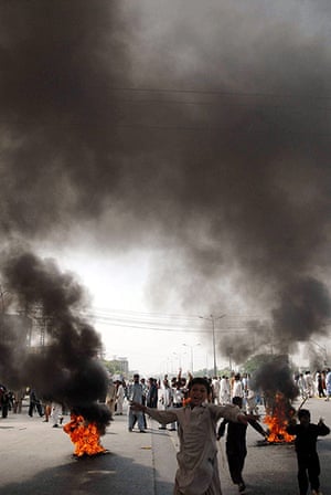 Film protests: Larkana, Pakistan: Tyres are burnt during a protest