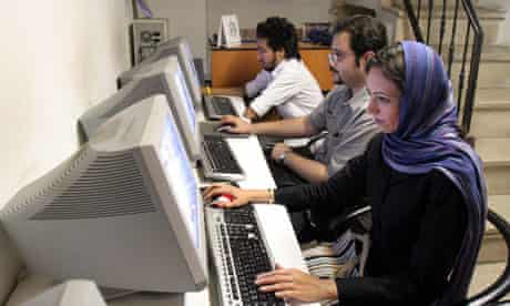 Iranians work at an internet cafe in Tehran