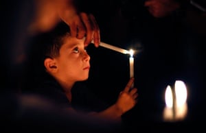 24 hours in pictures: Palestinian boy lights a candle 