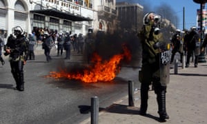 A molotov cocktail explodes beside riot police officers near Syntagma square 