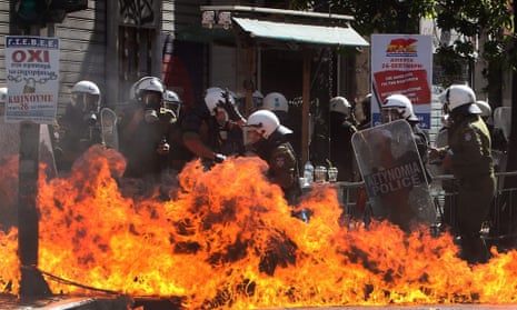 Riot policemen find themselves engulfed in flames during a general strike rally in Athens, Greece, 26 September 2012.