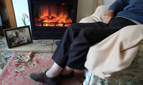 elderly people sitting by fireplace