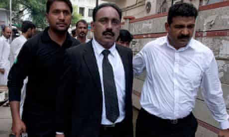 Tahir Naveed Chaudhry, a lawyer for Rimsha Masih, leaves court with an armed escort