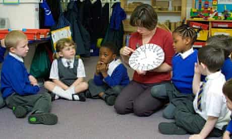 A teacher leads a lesson on numbers at a reception school
