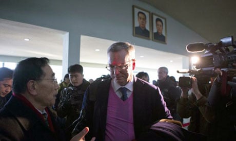 Eric Schmidt, the Google executive chairman, under portraits of Kim Il-sung and Kim Jong-il