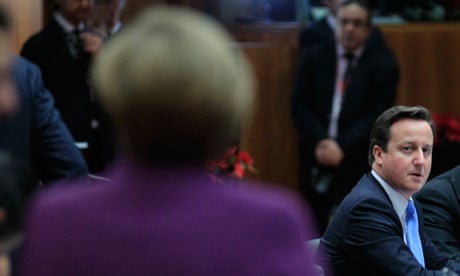 David Cameron looks toward German chancellor Angela Merkel at an EU summit
