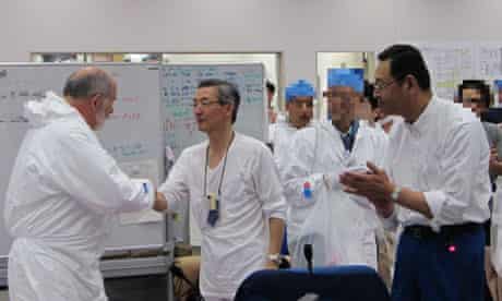 Atsufumi Yoshizawa meets a member of an IEA delegation at Fukushima Daiichi