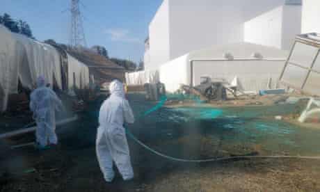 Tepco workers spray dust protectant near the Fukushima Daiichi plant