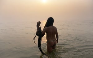 Kumbh Mela: A Saduh or holy man prays at daybreak 