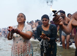 Kumbh Mela: Hindu devotees pray in the waters of the Sangham