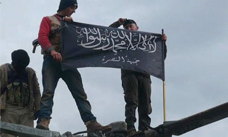 Al-Qaida affiliated Jabhat al-Nusra rebels hold up their flag after capturing Taftanaz air base