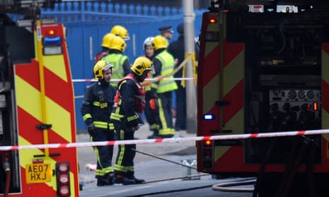 Police and firemen are seen at the site of a helicopter crash in Vauxhall, London.