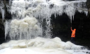 A man checks the size of the icicles at Gibson's Cave in Teesdale today as temperatures have reached