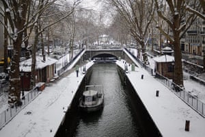 Paris snow: Snow covers paths alongside the Canal Saint-Martin 