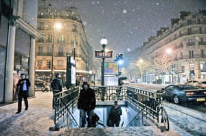 Paris snow: People leaving a Metro station in Paris under heavy snowfall