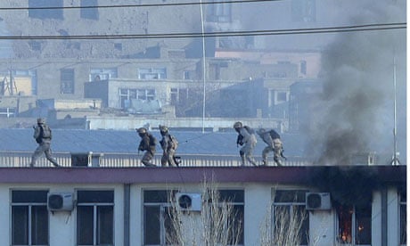 Afghan forces in Kabul run across the roof of the city's police headquarters