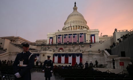 A member of the military stands guard at sun rise before the presidential inauguration in front of the U.S. Capitol in Washington, DC.