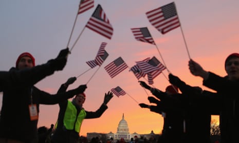 People wave flags as they gather near the Capitol building on the Mall.