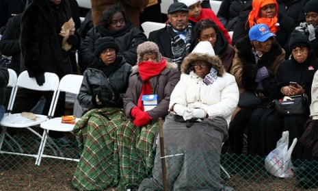 People try and stay warm as they wait for Obama to arrive.